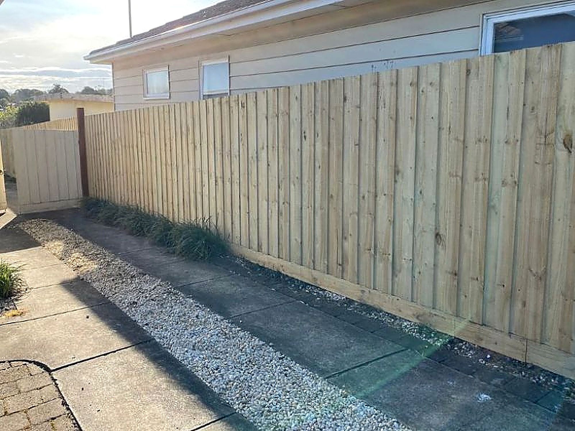 New treated pine paling fence along a side boundary in the Macedon Ranges