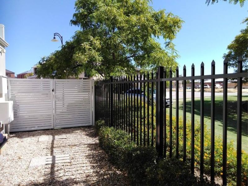 tubular alumnium fence with gate in background